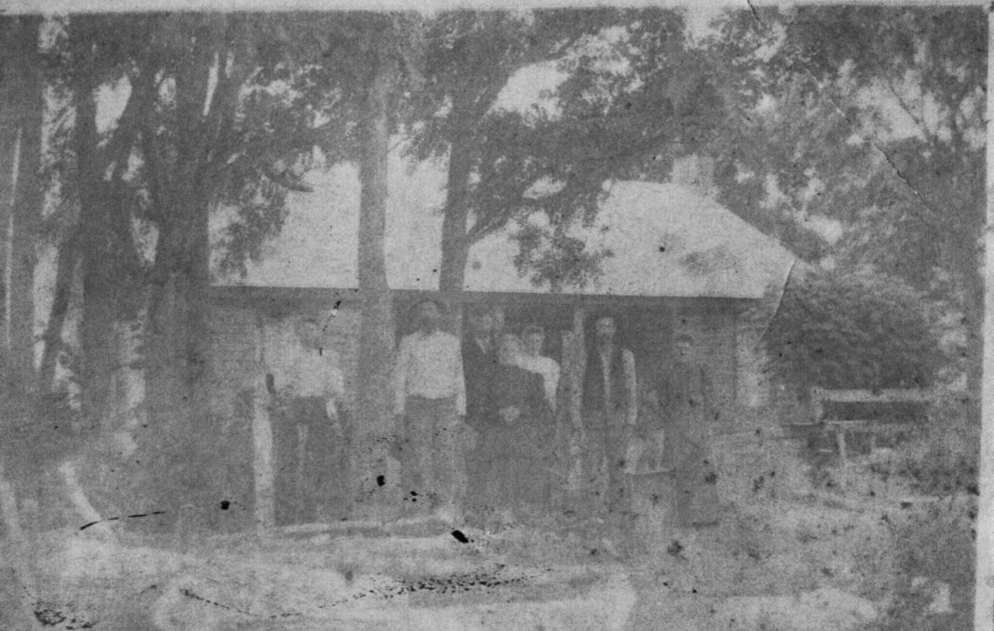 photo of wood house with family