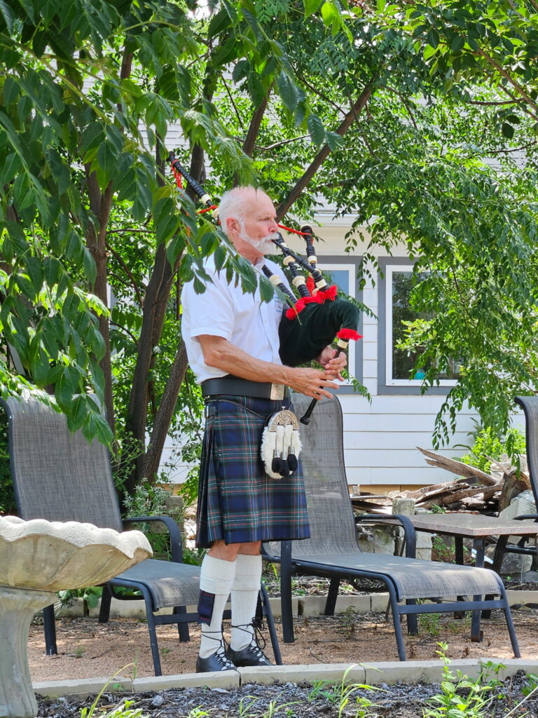 Man in kilt playing bagpipes