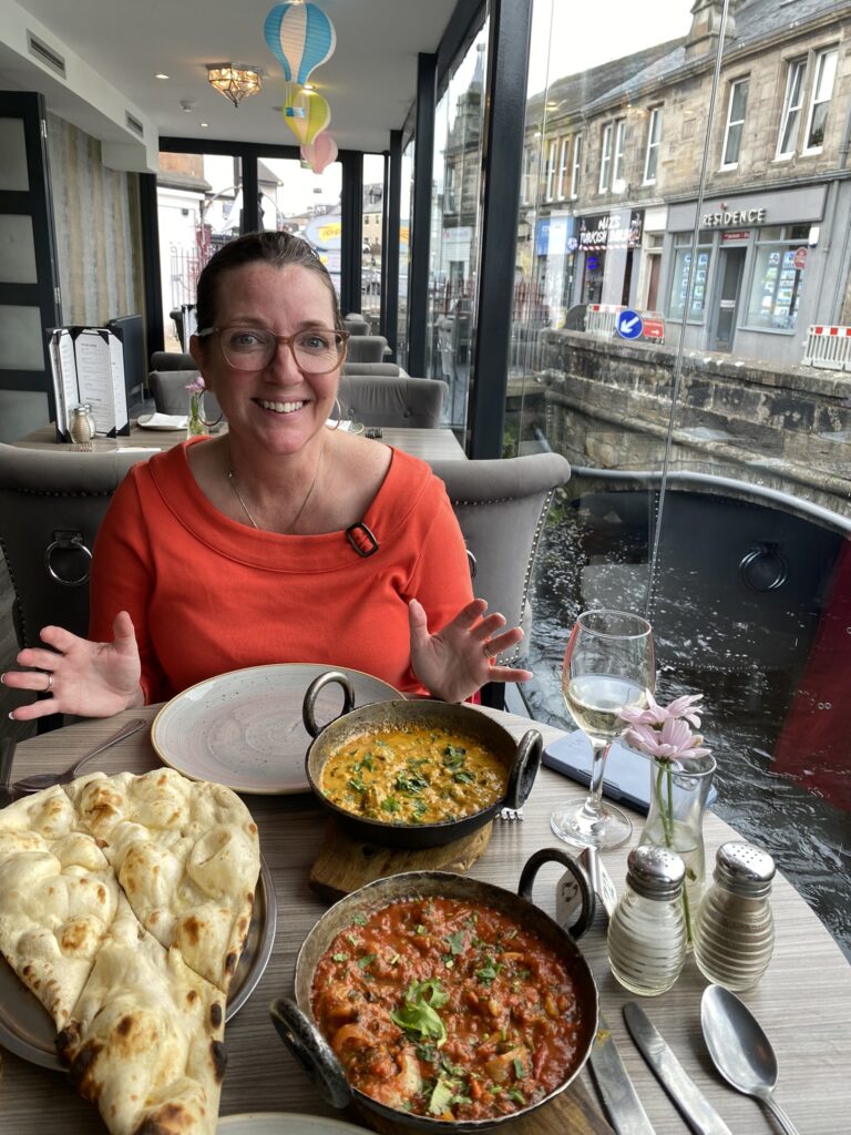 Jana sitting at Taal restaurant table